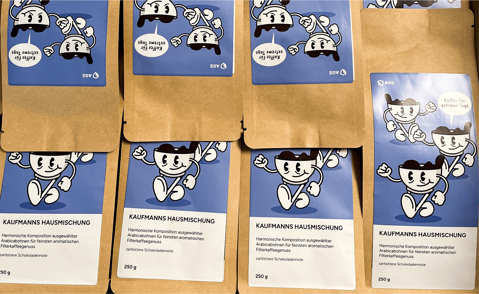 Brown coffee bags with blue labels showing smiling walking coffee cup mascot