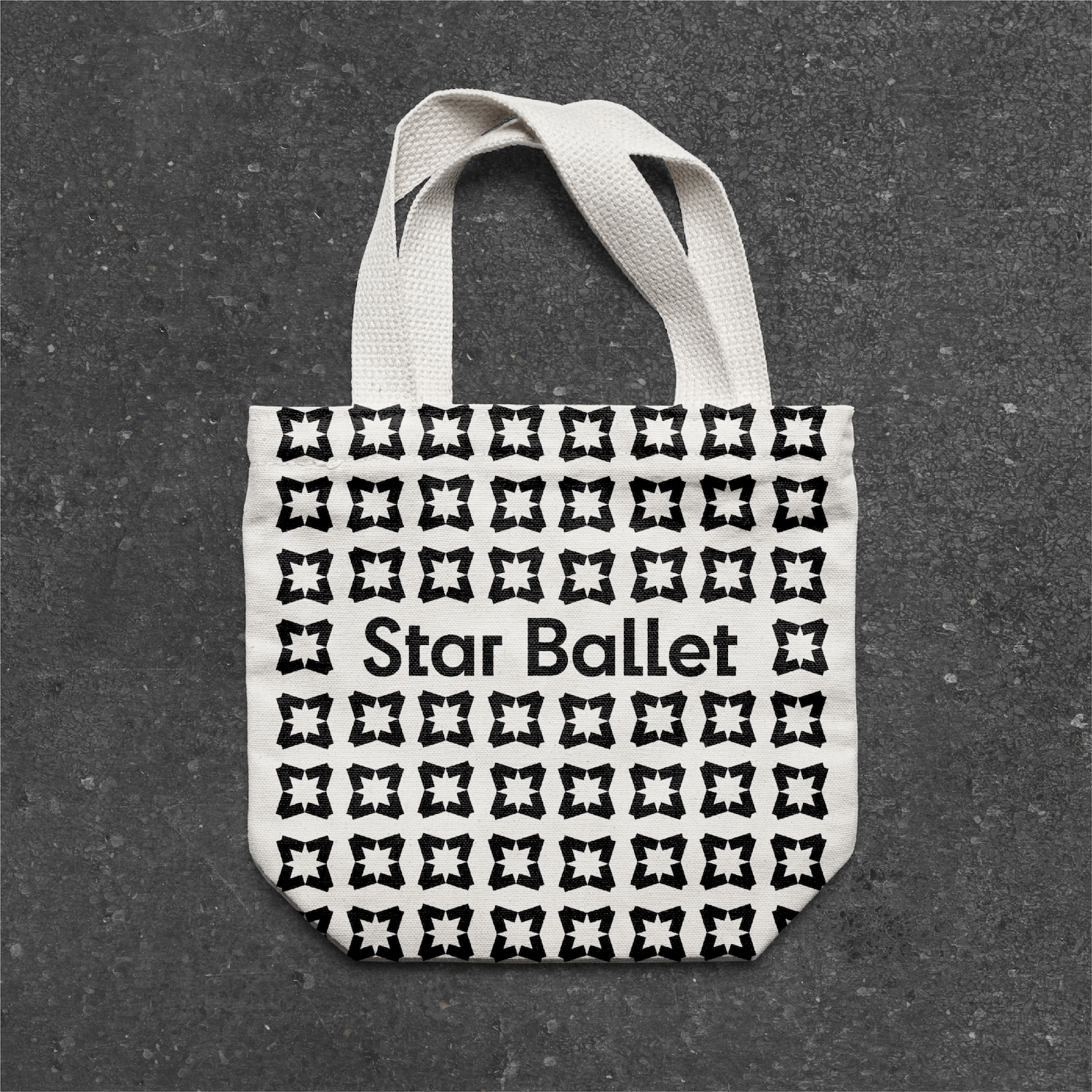 White tote bag with repeating Star Ballet logo pattern
