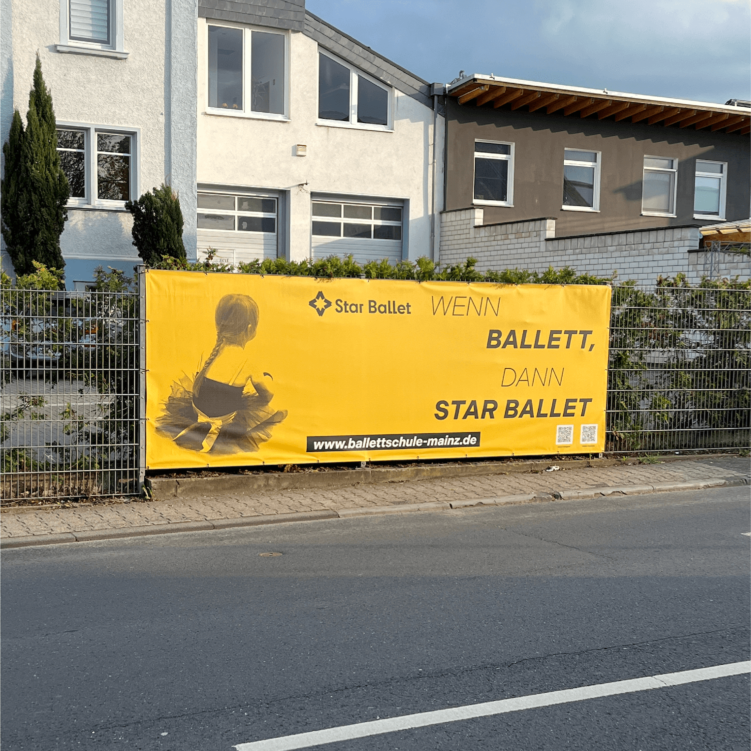 Large roadside billboard with yellow background advertising Star Ballet