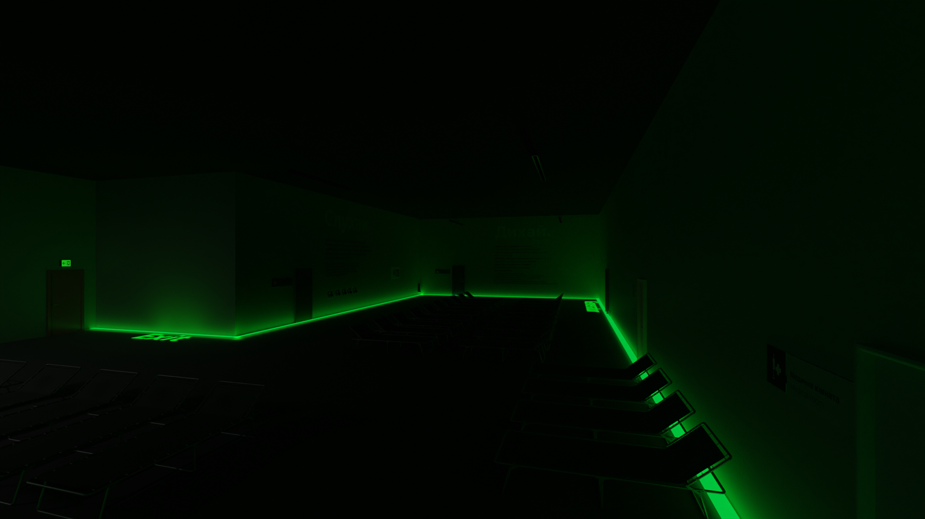 Dimly lit interior with green emergency lighting and rows of beds