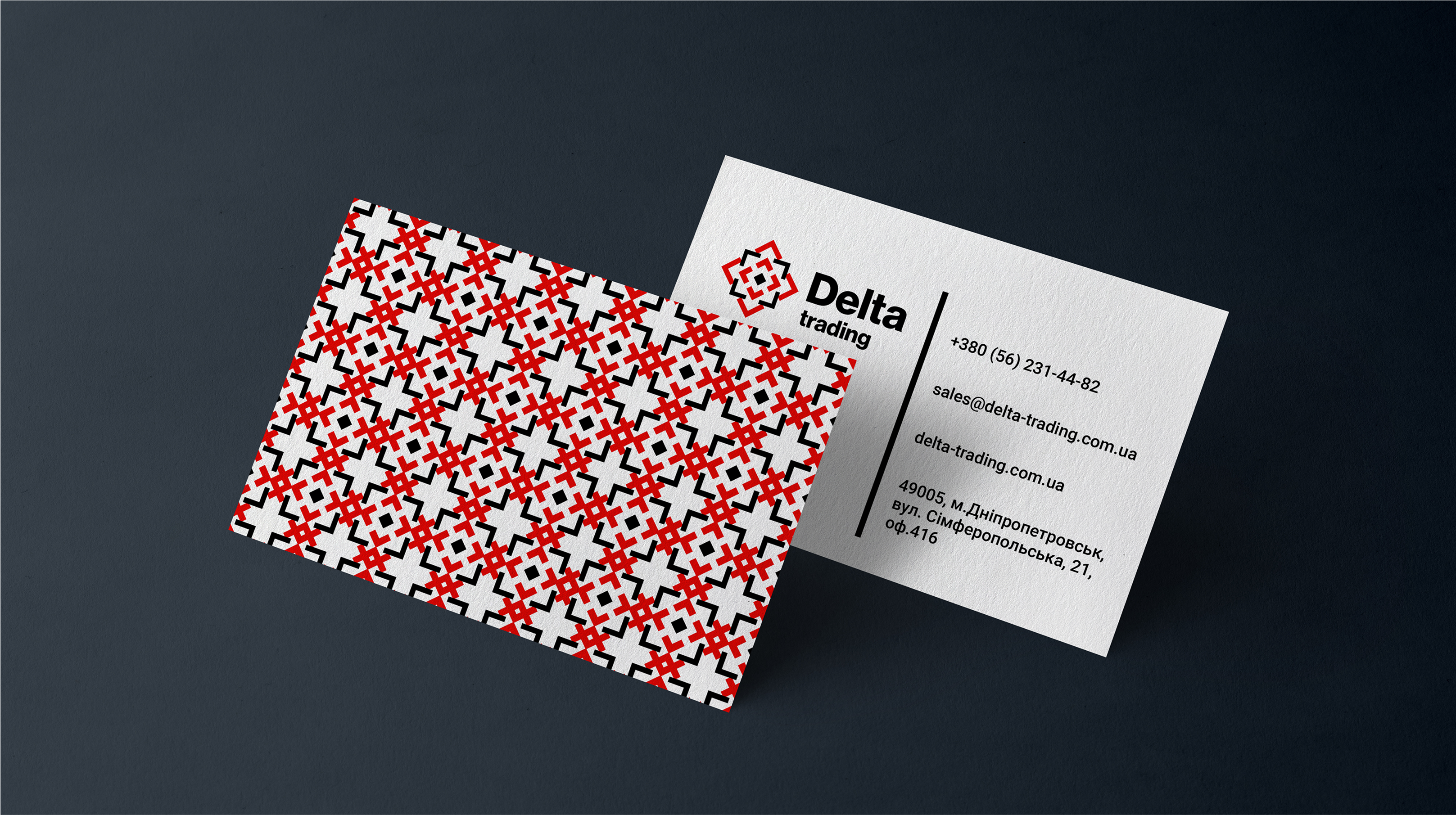 Delta Trading business card featuring a red and black embroidery pattern and clean contact details