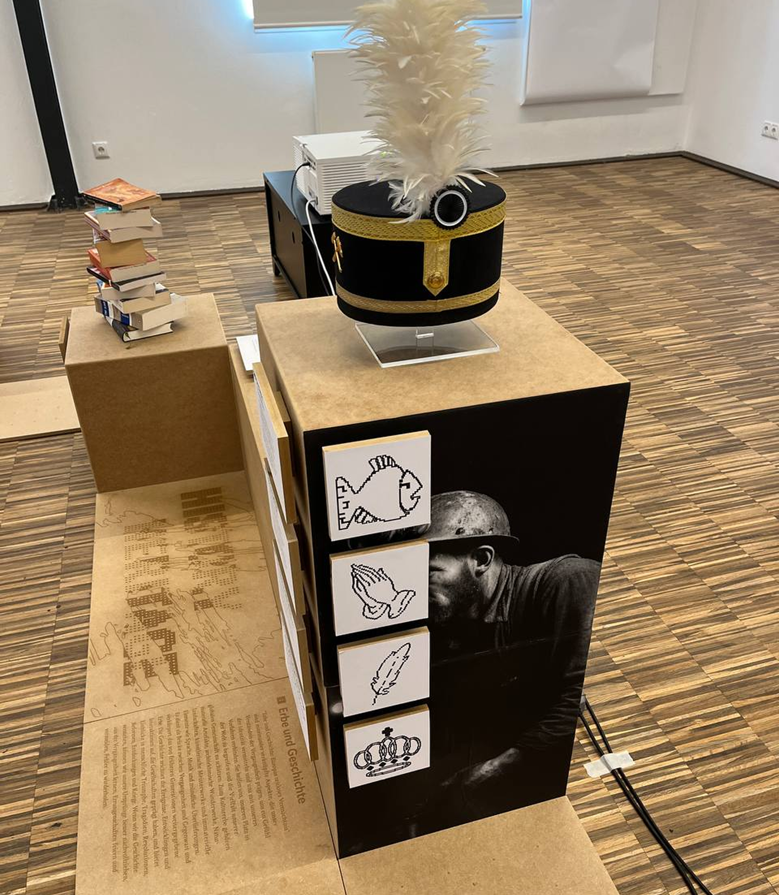 Exhibition pedestal with miner’s portrait, helmet display, and symbolic icon tiles
