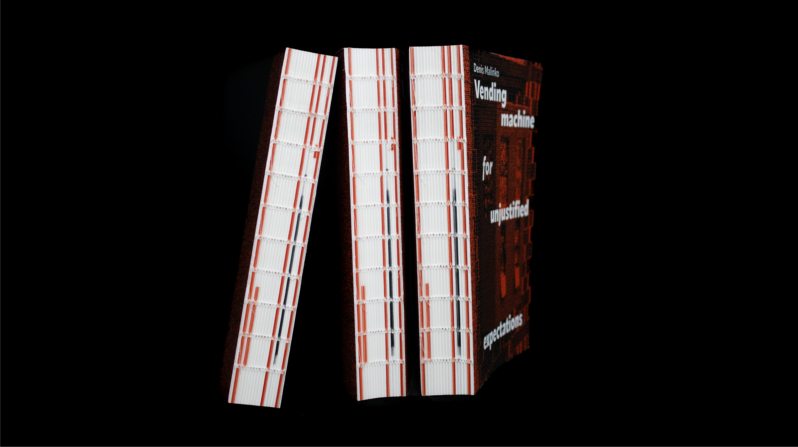 Angled view of book showing cover and thick spine with red detailing