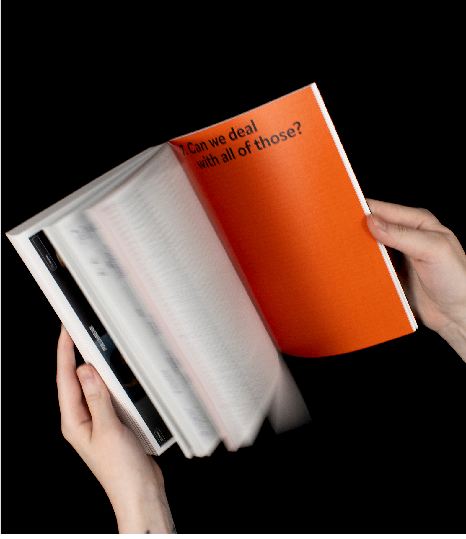 Book held open to orange page reading “Can we deal with all of those?”