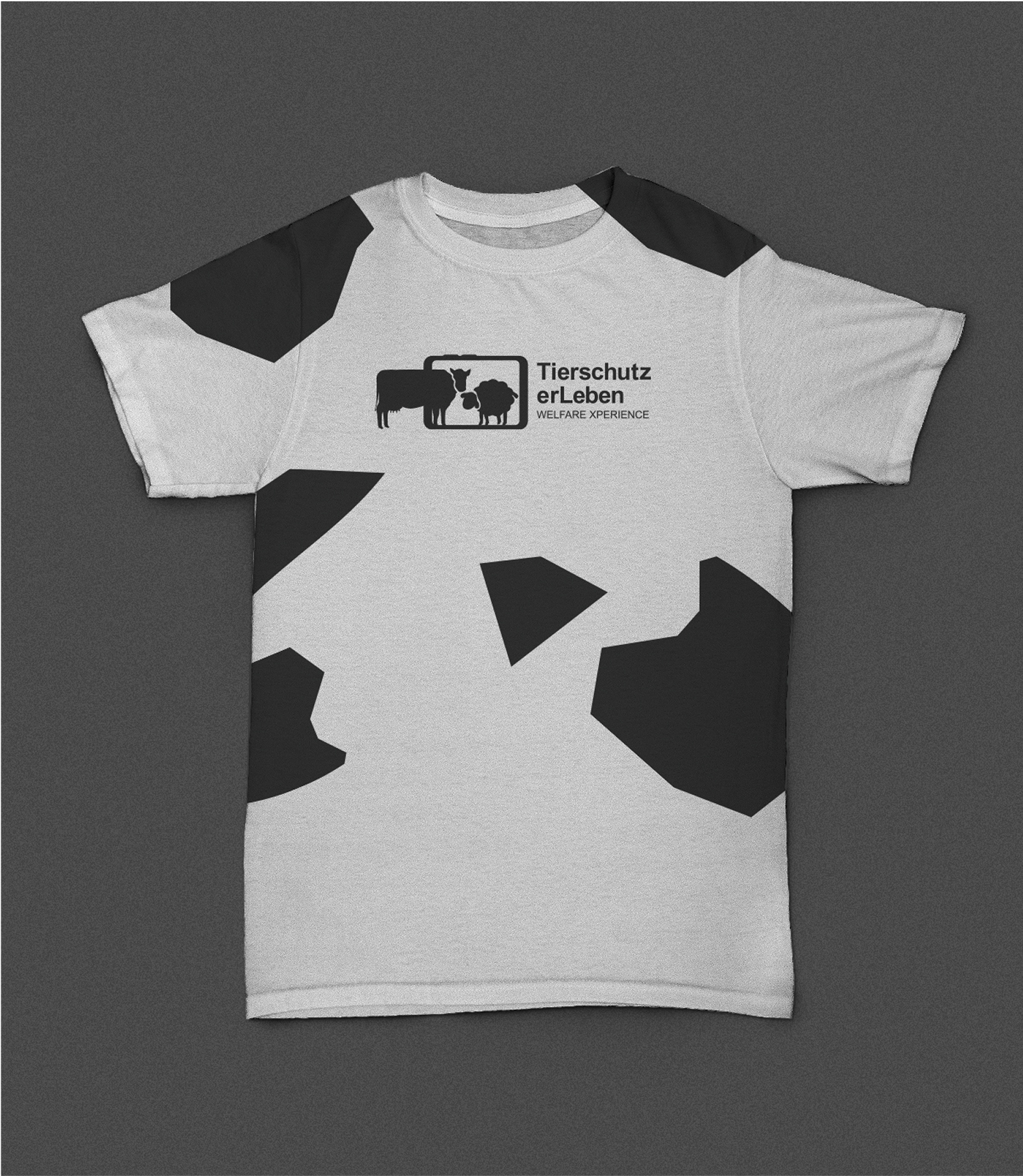 Cow-patterned T-shirt with “Tierschutz erLeben” logo